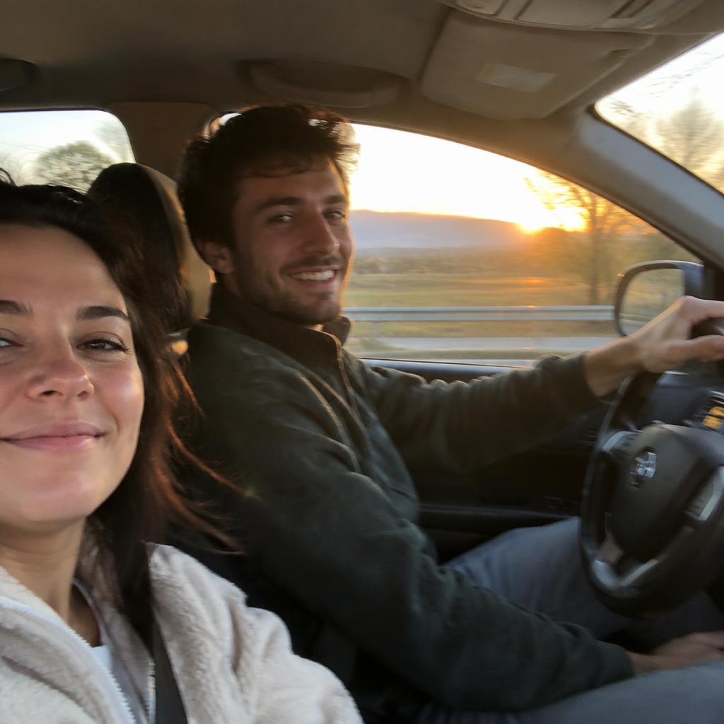 A candid photo of a couple on a road trip at golden hour, taken from the passenger seat